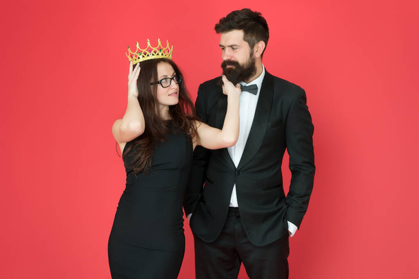 Falling in love with boss. Couple in love red background. Beauty queen and bearded man. Egoistic love. Prom party. Date and dating. Love and romance. Romantic relationship. Valentines day - Фото, изображение