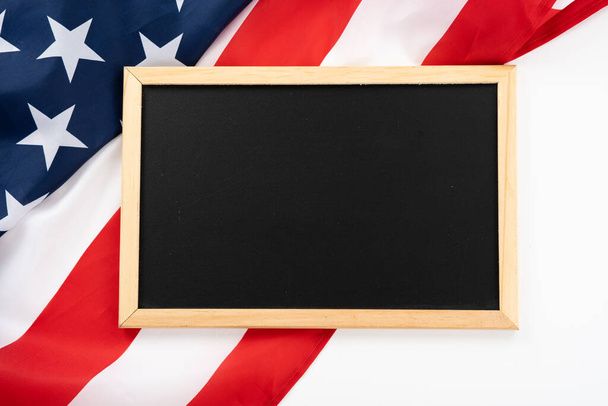 US American flag with blackboard on white background. For USA Memorial day, Presidents day, Veterans day, Labor day, Independence or 4th of July celebration. Top view, copy space for text. - Photo, Image