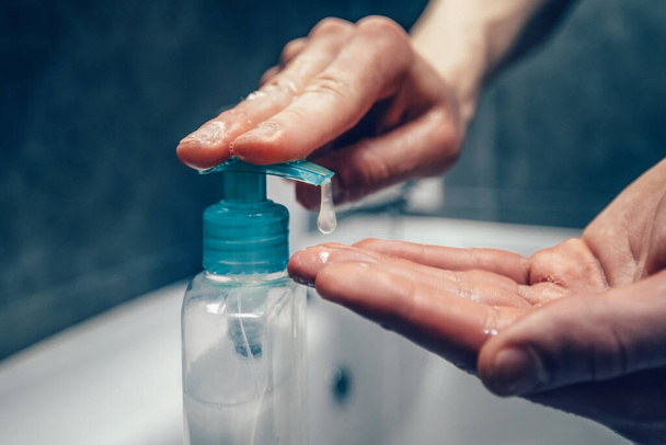 close up. young man using an antiseptic soap . - Фото, изображение