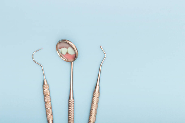 Zubní nářadí v zubní ordinaci, zrcadlo a háček. Koncept péče o zuby - Fotografie, Obrázek