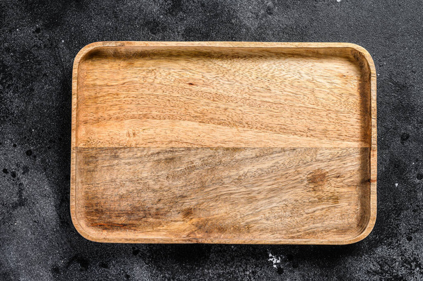 Wooden antique tray. Black texturized background. Top view. Copy space. - Fotoğraf, Görsel