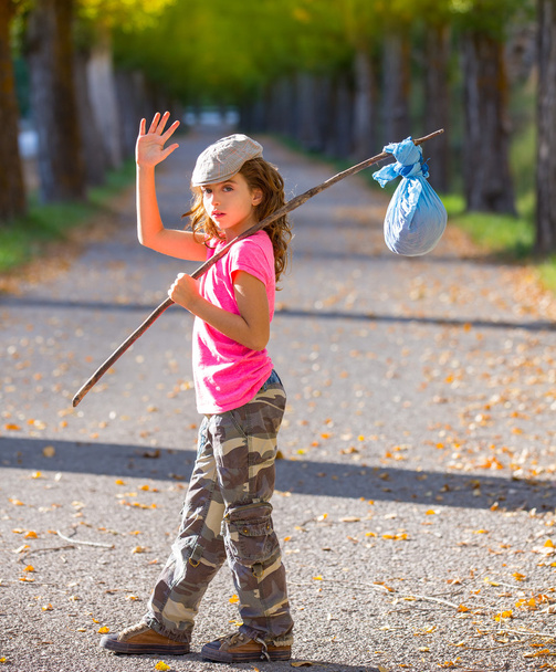 little kid with hobo stick bag and bundle girl saying goodbye - Foto, afbeelding