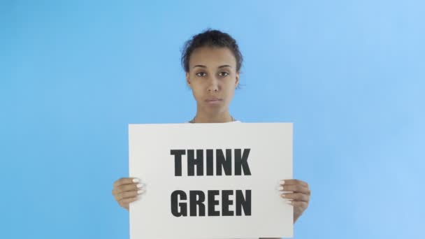Afro-American Girl Activist With Think Green Poster on blue background - Πλάνα, βίντεο
