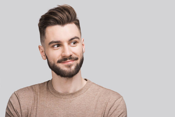 Handsome smiling young man isolated on gray background closeup portrait. Laughing joyful cheerful men studio shot - Photo, Image