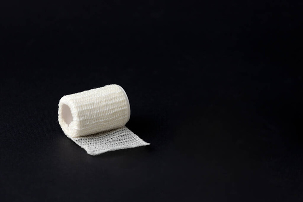 Bandage on a black background to mean a concept of health and prevention - Valokuva, kuva