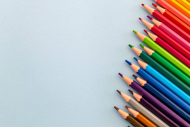 una selección de lápices coloreados alineados en una fila a una inclinación.  - Foto, imagen