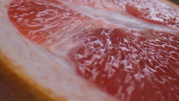 grapefruit macro shooting,isolated half grapefruit on yellow background rotates - Filmati, video