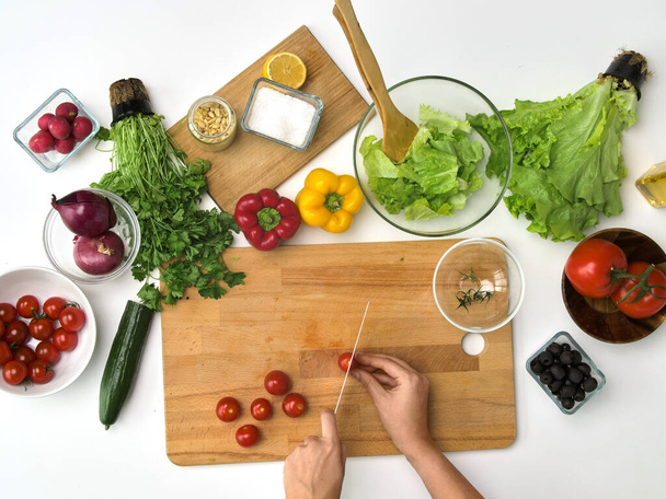 Frau hackt Tomaten mit Messer in Küche - Foto, Bild