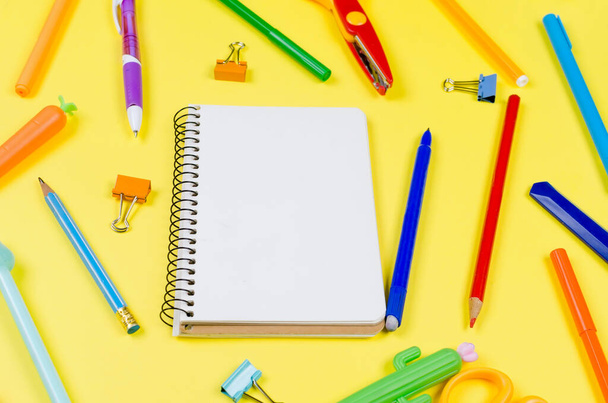 Colored different school supplies on soft yellow paper background. Notebook, pens, pencils and other tools. Back to school background. Flat lay, top view, copy space. Banner for site. - Fotoğraf, Görsel