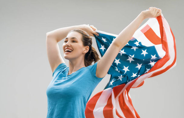 Patriotic holiday. Happy young woman with American flag. USA celebrate 4th of July. - Fotoğraf, Görsel