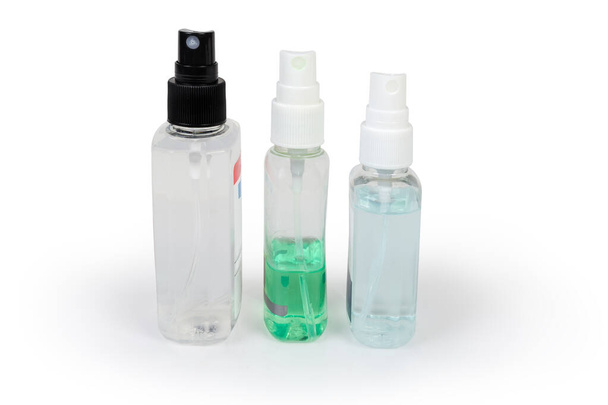 Diverse piccole bottiglie di plastica degli antisettici sotto forma di spray su uno sfondo bianco
 - Foto, immagini