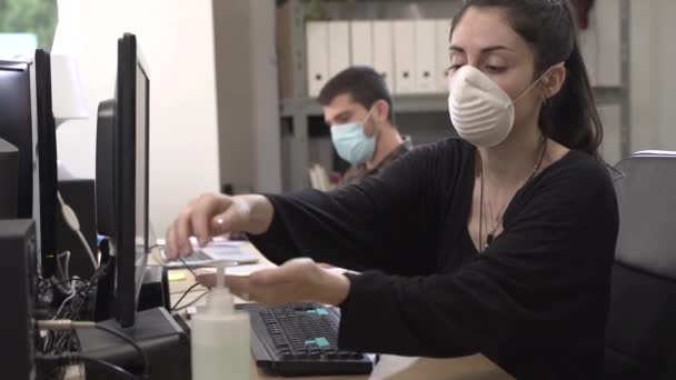 Coronavirus. Business workers working from home wearing protective mask. Small company in quarantine for coronavirus working from home with sanitizer gel. Small company concept. - Video, Çekim