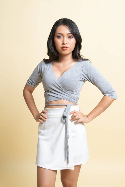 Portrait of beautiful young Asian woman   on beige background - Valokuva, kuva