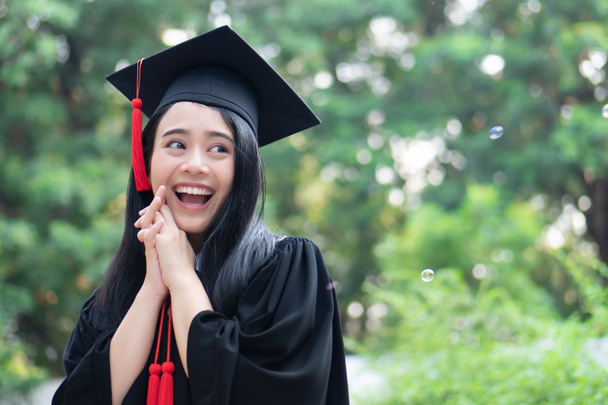 happy smiling college student graduating looking up; concept of successful education, happy commencement day, woman education opportunity, graduation, education vision, overseas study scholarships - Photo, Image