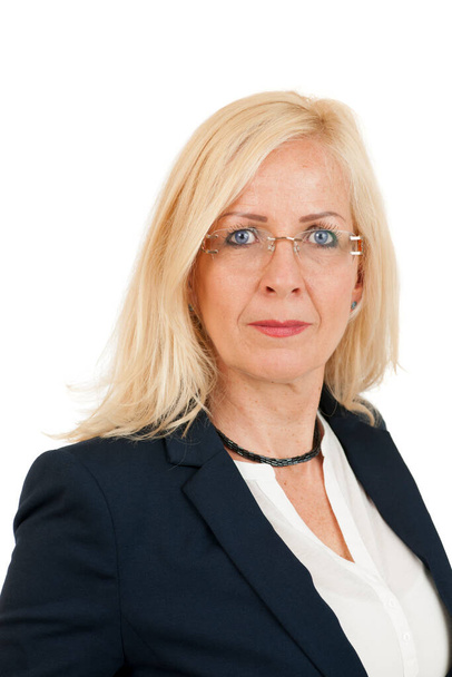 Side head-and-shoulders portrait of a blonde, long-haired middle-aged woman in a black blazer, confidently looking at the camera against a white background. - Foto, immagini