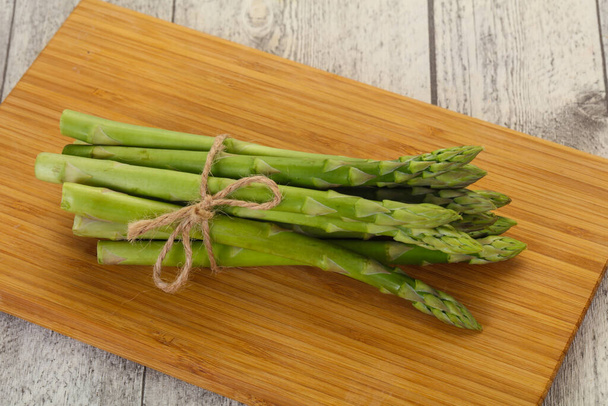 Raw asparagus heap over the wooden board - Photo, Image
