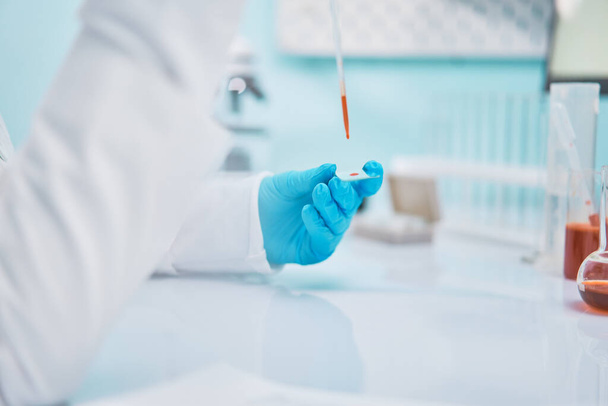Woman lab assistant with pipette , blurred background. - Photo, Image