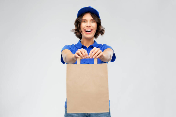delivery woman with takeaway food in paper bag - 写真・画像