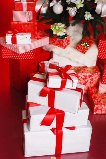 Christmas background with a red ornament, red gift boxes, red christmas balls - Fotó, kép