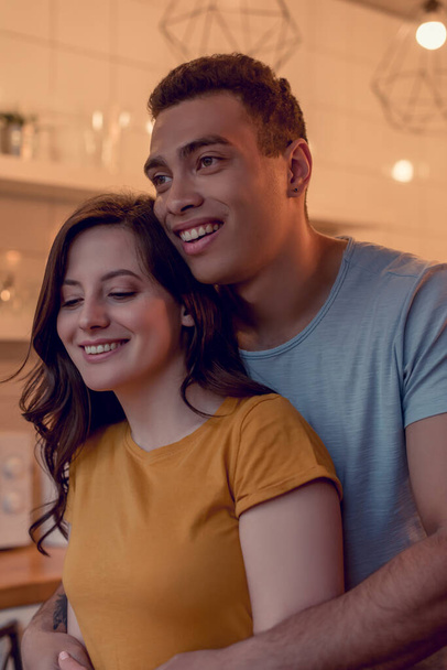 happy multiracial couple smiling at home - Foto, immagini