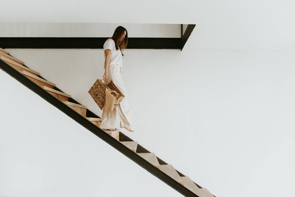 Woman going down the stairs. - Zdjęcie, obraz