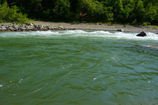 Στο ποτάμι ανάμεσα σε απόκρημνους βράχους. καταγάλανα καθαρά νερά του ποταμού. - Φωτογραφία, εικόνα