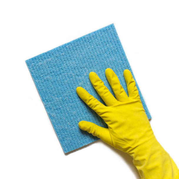 Isolated female hand in yellow rubber glove with blue microfiber cloth on white background. - Foto, immagini