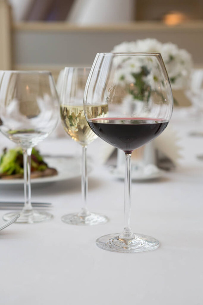 Glass of red wine on a restaurant table - Fotoğraf, Görsel