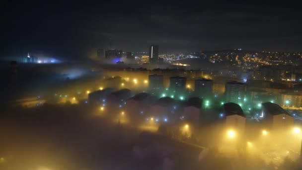 Cinematic 8K 7680x4320.The houses and streets in the city are under the mist.Street lamp lights in mist.Weather opposition negatively affecting life at night.City town street road centrum building house houses metropolis haze mist settlement foggy 8K - Footage, Video