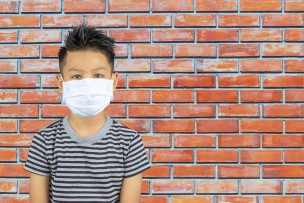 Portrait  Asian boy wearing a mask background brick wall. - Foto, Imagem