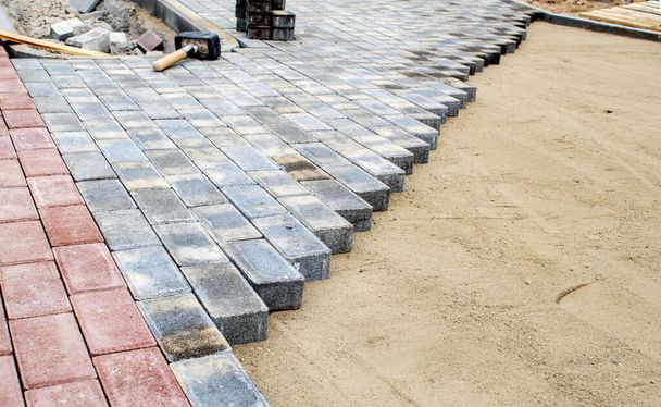 строительство нового современного тротуара из плитки на открытом воздухе в солнечный день
 - Фото, изображение
