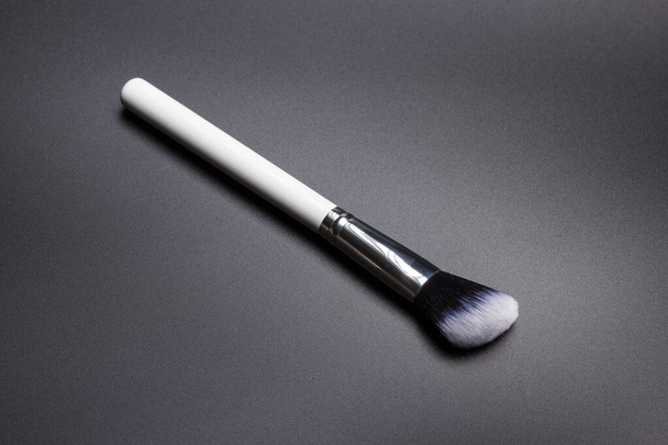 Highlighter make up brush on black background - Φωτογραφία, εικόνα