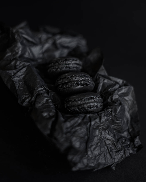 black macaroons on black paper - Foto, Imagem