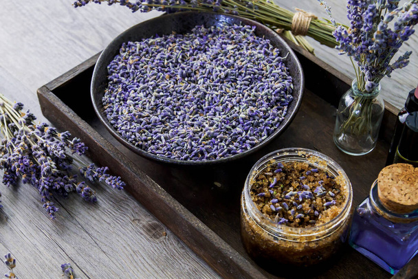 Lavender flowers and natural cosmetics in wooden tray - Photo, image