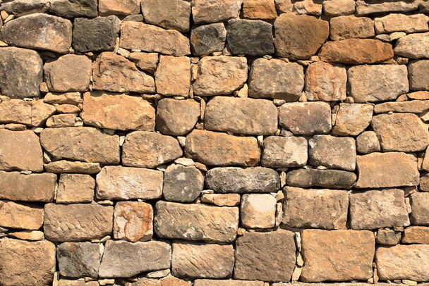 Big yellow wall made from stone bricks - Photo, Image
