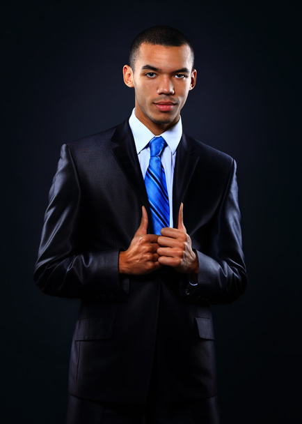 Young handsome African-American businessman in black suit. - Фото, зображення