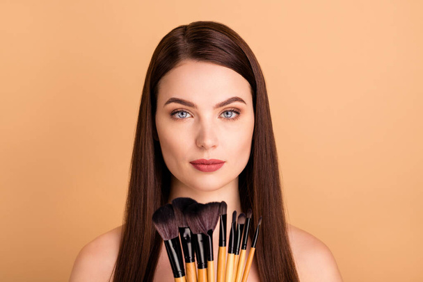 Close up photo of gorgeous woman hold brushes want use apply eye shadows rouge to prepare for prom party event advertising concept isolated over beige color background - Photo, image