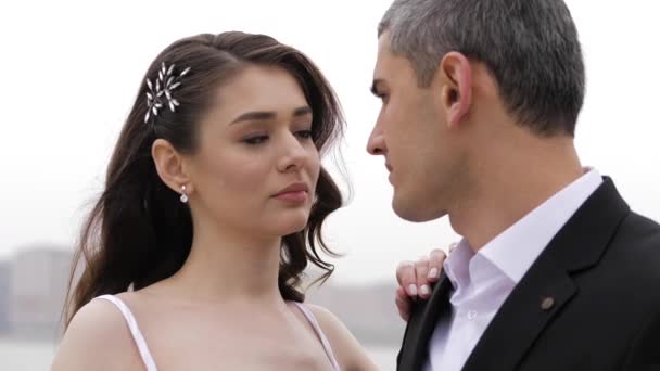 brunette looks into elegant fiance in black suit eyes posing - Záběry, video