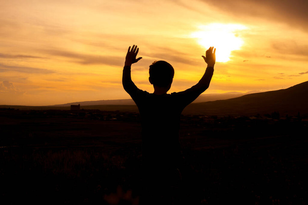 Young boy hands up towars sunset - Photo, Image