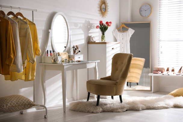 Stylish room interior with elegant dressing table, mirror and comfortable chair - Photo, Image
