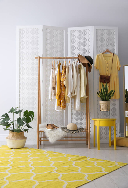 Rack with stylish women's clothes indoors. Interior design - Fotografie, Obrázek