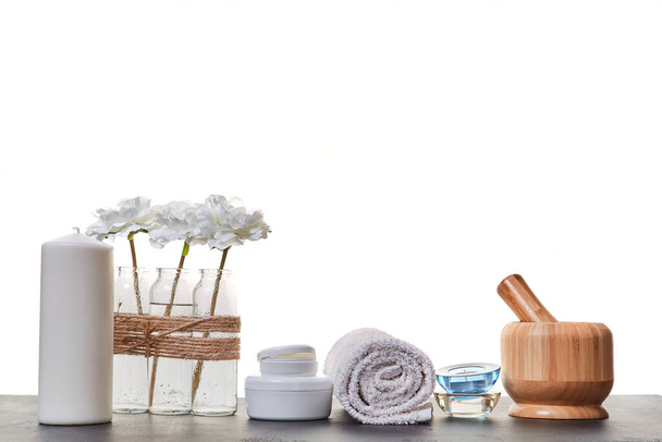 Aromatic oils. Spa day. Skincare. Wooden mortar tubes with cream. Candles and white towel. White backdrop. Copy space - Foto, Imagem