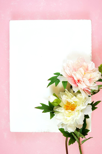 Pink and white peony flowers decorated border on modern pink textured background - Foto, afbeelding