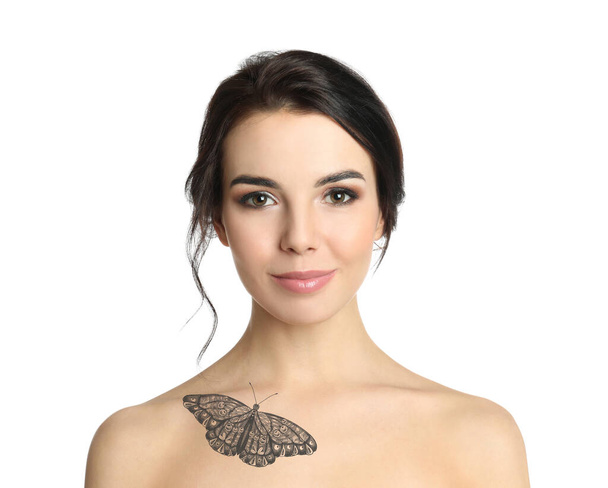 Young woman with beautiful tattoo of butterfly on her body against white background - Valokuva, kuva