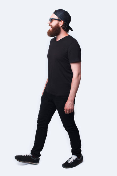 Full length photo of bearded hispter man walking over white - Photo, image