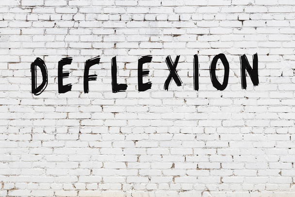 Word deflexion painted on white brick wall - Photo, Image