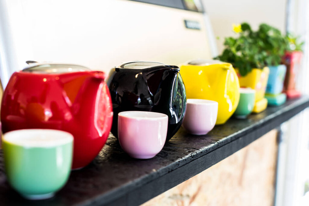 The pot tea and tea cups on the shelves. - Photo, Image