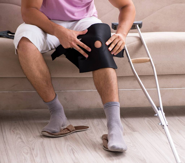 Patient Standing On Crutch In Hospital Ward Ware Knee Brace Support After  Do Posterior Cruciate Ligament Surgery Bandage On Knee Of Asian Woman On  Crutcheshealthcare And Medical Concept Stock Photo - Download
