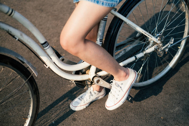 Girl on a white bicycle. - Фото, зображення