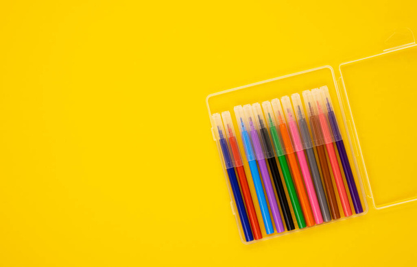 multi-colored markers in a package on a yellow background. educational school supplies. stationery for the office. back to school. online learning - Foto, Imagen